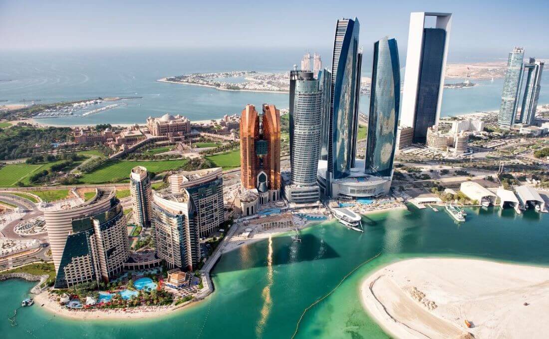 A comparison image of Abu Dhabi and Dubai landmarks and attractions showcasing the differences between Abu Dhabi vs Dubai