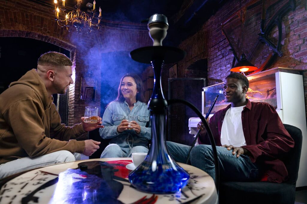 A picture of a shisha cafe in Dubai with people smoking shisha pipes