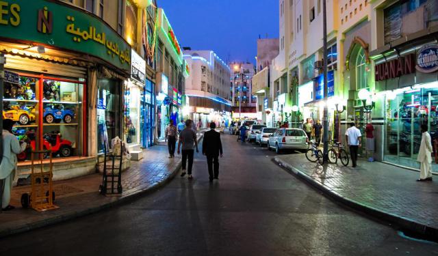 An image showing the bustling streets of Deira, the location of the venue and its opening hours.