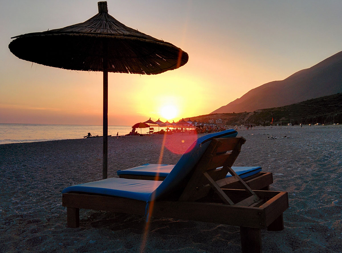 A beach club with sun loungers and umbrellas at Nikki Beach in Dubai