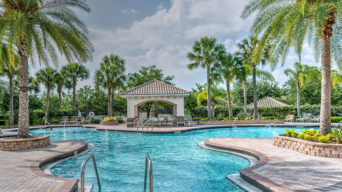 A beach resort with a swimming pool and palm trees in Dubai